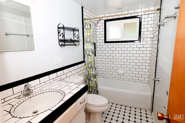 a bathroom with a bathtub and a toilet