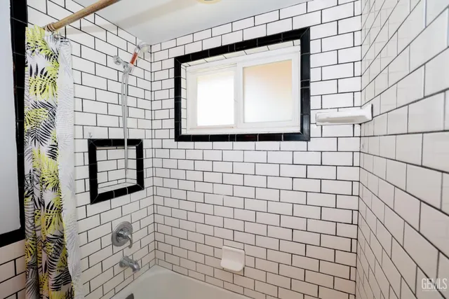 a bathroom with a shower and a mirror