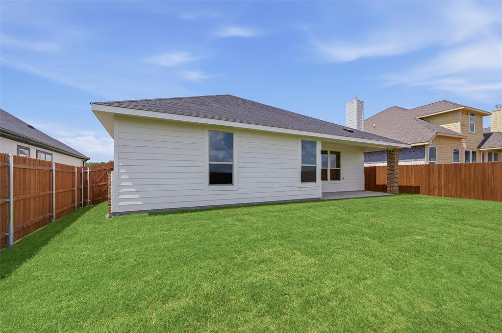 1209 Colca Drive Springtown, TX 76082 - Photo 23 of 24 Expansive backyard featuring a manicured lawn, full wood fencing, and a concrete patio