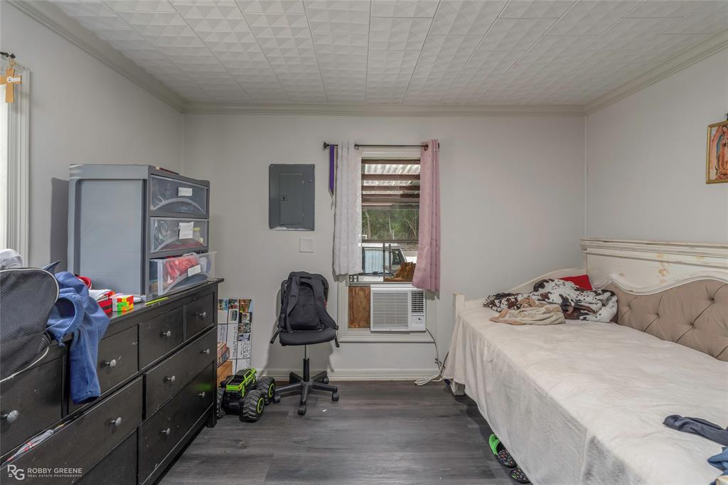 143 New Bethel Booker Road Benton, LA 71006 - Photo 14 of 26 Interior room featuring wood-finish flooring, light neutral wall paint, and a patterned ceiling