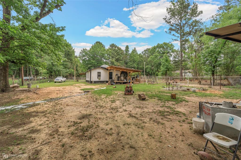 143 New Bethel Booker Road Benton, LA 71006 - Photo 17 of 26 Expansive outdoor area featuring a white-sided residence with an inviting covered porch