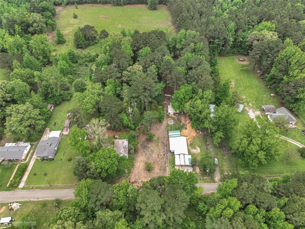 143 New Bethel Booker Road Benton, LA 71006 - Photo 20 of 26 Aerial perspective showcasing a property surrounded by mature trees and verdant landscape