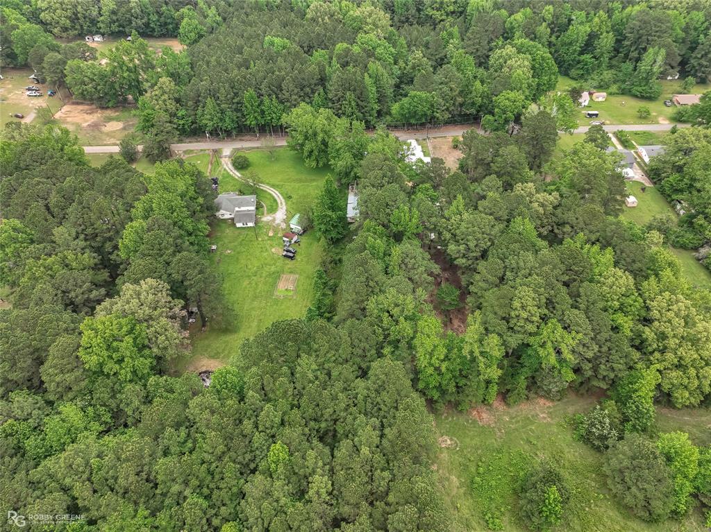 143 New Bethel Booker Road Benton, LA 71006 - Photo 23 of 26 Expansive property featuring a single-story residence with a light-colored roof and siding