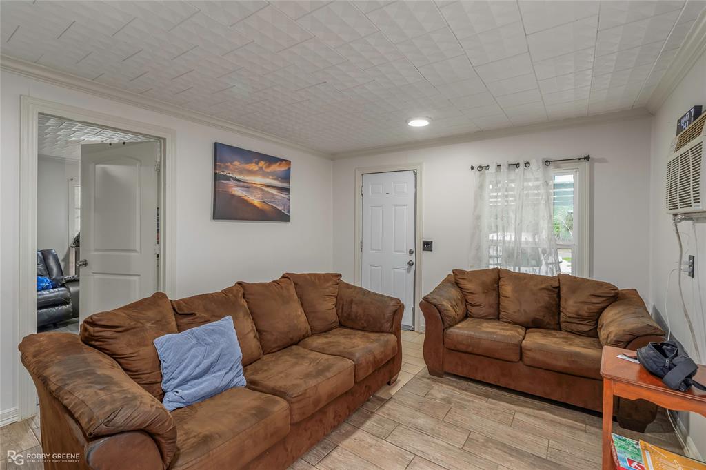 143 New Bethel Booker Road Benton, LA 71006 - Photo 3 of 26 Bright living area featuring wood-finish flooring, white walls, and a textured ceiling