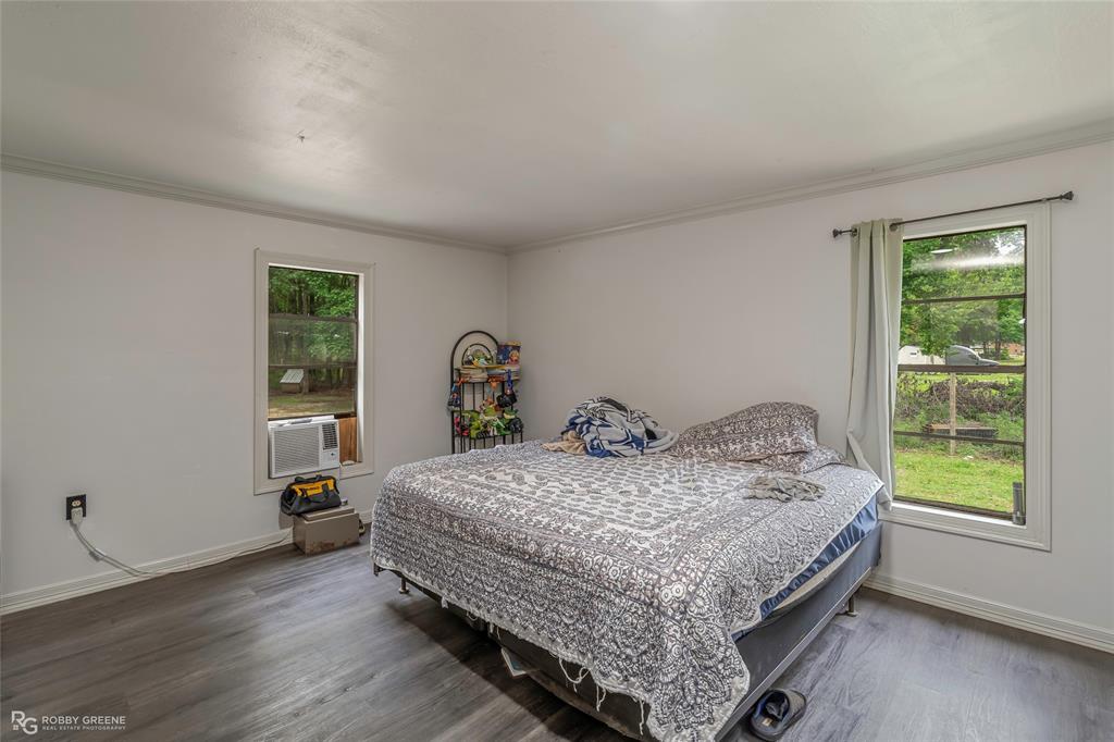 143 New Bethel Booker Road Benton, LA 71006 - Photo 6 of 26 Spacious room featuring wood-finish flooring, white walls, and two windows providing natural light