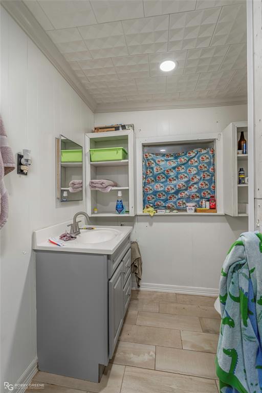 143 New Bethel Booker Road Benton, LA 71006 - Photo 10 of 26 Bathroom vanity featuring a single basin sink, brushed nickel faucet, and gray cabinetry with a white countertop