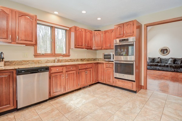 583 Sugar Road Bolton, MA 01740 - Photo 13 of 30 a kitchen with stainless steel appliances granite countertop a stove sink and cabinets