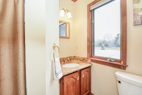 583 Sugar Road Bolton, MA 01740 - Photo 16 of 30 a bathroom with a granite countertop sink and a mirror