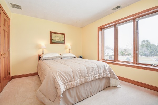 583 Sugar Road Bolton, MA 01740 - Photo 22 of 30 a bed sitting in a bedroom next to a window