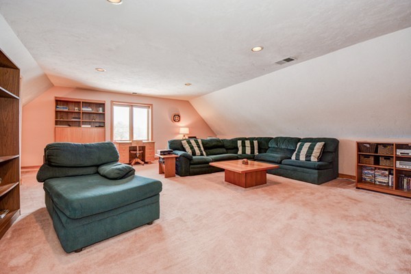 583 Sugar Road Bolton, MA 01740 - Photo 25 of 30 a living room with furniture and a book shelf