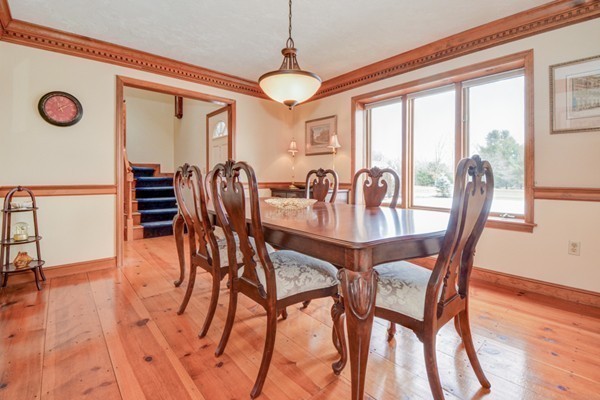 583 Sugar Road Bolton, MA 01740 - Photo 4 of 30 a view of a dining room with furniture window and wooden floor