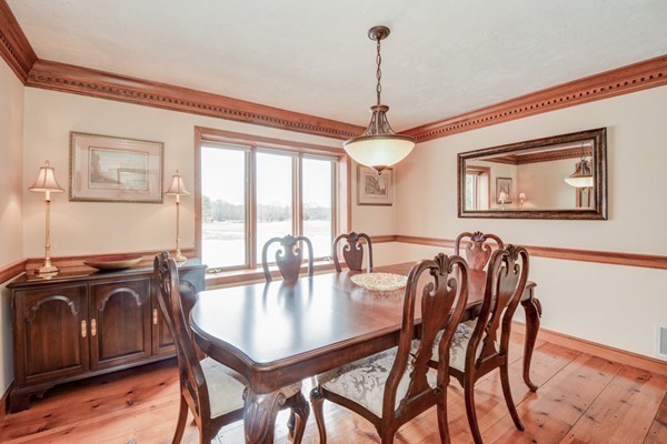583 Sugar Road Bolton, MA 01740 - Photo 5 of 30 a dining room with furniture a chandelier and wooden floor