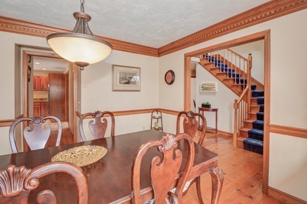 583 Sugar Road Bolton, MA 01740 - Photo 6 of 30 a dining room with furniture and a chandelier