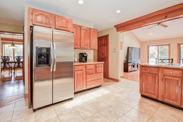 583 Sugar Road Bolton, MA 01740 - Photo 7 of 30 a large kitchen with stainless steel appliances kitchen island granite countertop a refrigerator and a sink