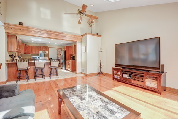 583 Sugar Road Bolton, MA 01740 - Photo 9 of 30 a living room with dining room and a flat screen tv