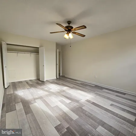 a view of a room with a ceiling fan