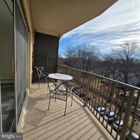 a view of balcony with wooden floor and outdoor seating
