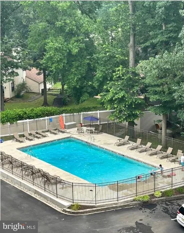 a view of a swimming pool with a lounge chair
