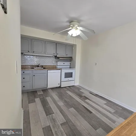 a view of a kitchen with a sink cabinets and stainless steel appliances