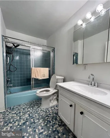 a bathroom with a toilet a sink and shower