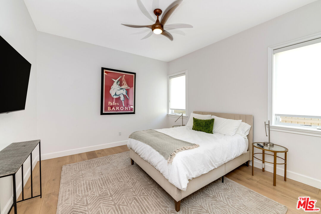 4843 Ledge Avenue Toluca Lake, CA 91601 - Photo 14 of 31 a bedroom with a bed and a flat screen tv