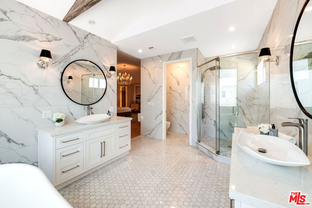 4843 Ledge Avenue Toluca Lake, CA 91601 - Photo 20 of 31 a bathroom with a sink a toilet and a mirror