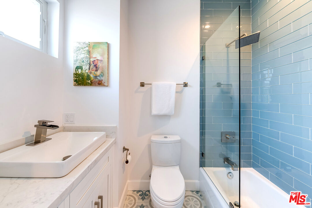 4843 Ledge Avenue Toluca Lake, CA 91601 - Photo 26 of 31 a bathroom with a sink a toilet and shower