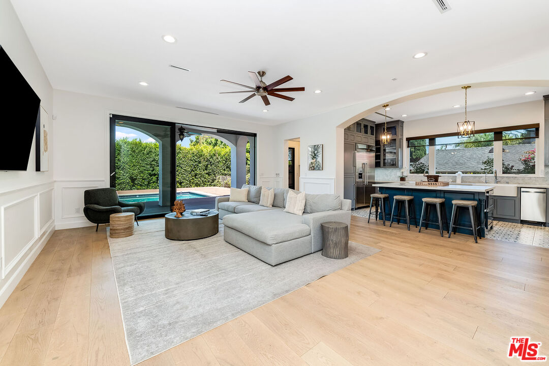 4843 Ledge Avenue Toluca Lake, CA 91601 - Photo 4 of 31 a living room with furniture a flat screen tv and a large window