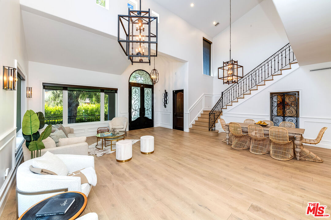 4843 Ledge Avenue Toluca Lake, CA 91601 - Photo 10 of 31 a view of a dining room with furniture a chandelier and wooden floor