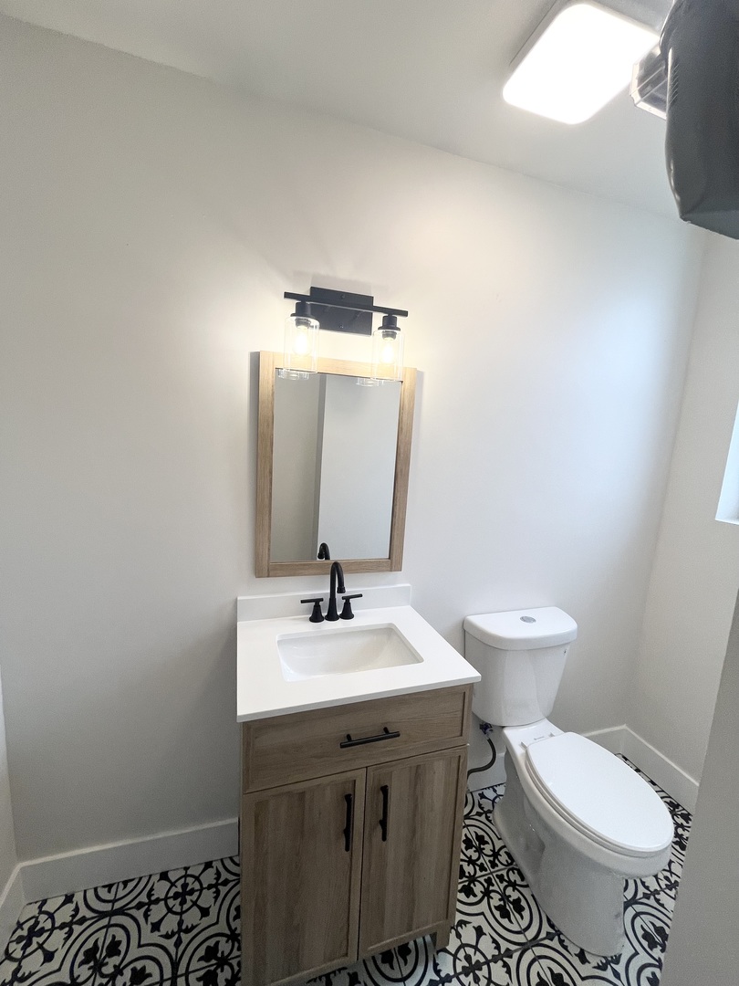 2512 South Trumbull Avenue, Unit 3R Chicago, IL 60623 - Photo 12 of 13 a bathroom with a sink toilet and mirror