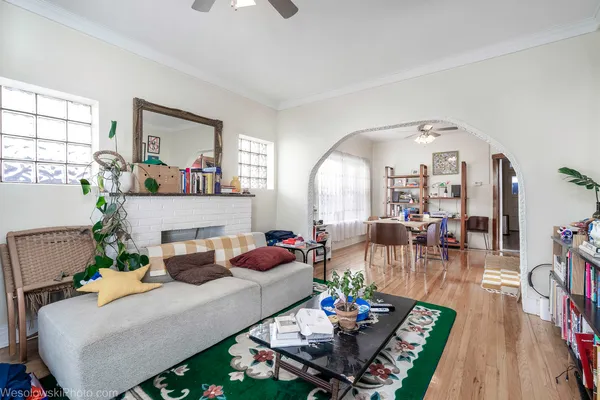 a living room with furniture and wooden floor