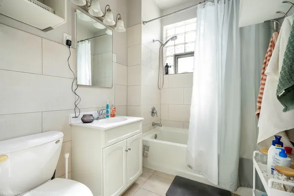 a bathroom with a sink toilet vanity and shower