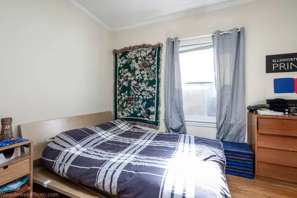 a bedroom with a bed and a window