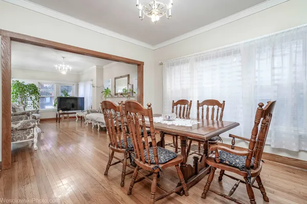 a view of a dining room with furniture and wooden floor