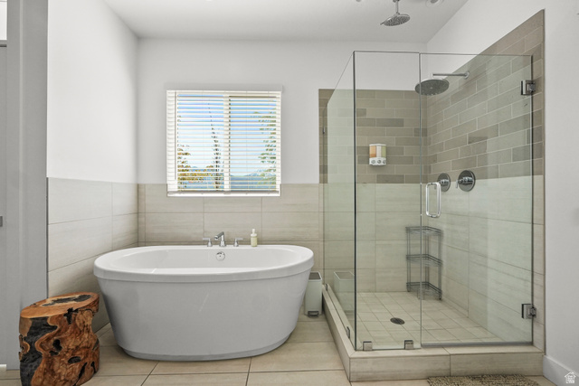 15008 South Springtime Road Draper, UT 84020 - Photo 20 of 37 Full bathroom featuring a freestanding tub, a stall shower, tile walls, wainscoting, and light tile patterned floors