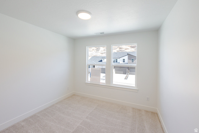 4720 Heartwood Road, Unit 438 Mapleton, UT 84664 - Photo 16 of 19 Spare room featuring light colored carpet and baseboards