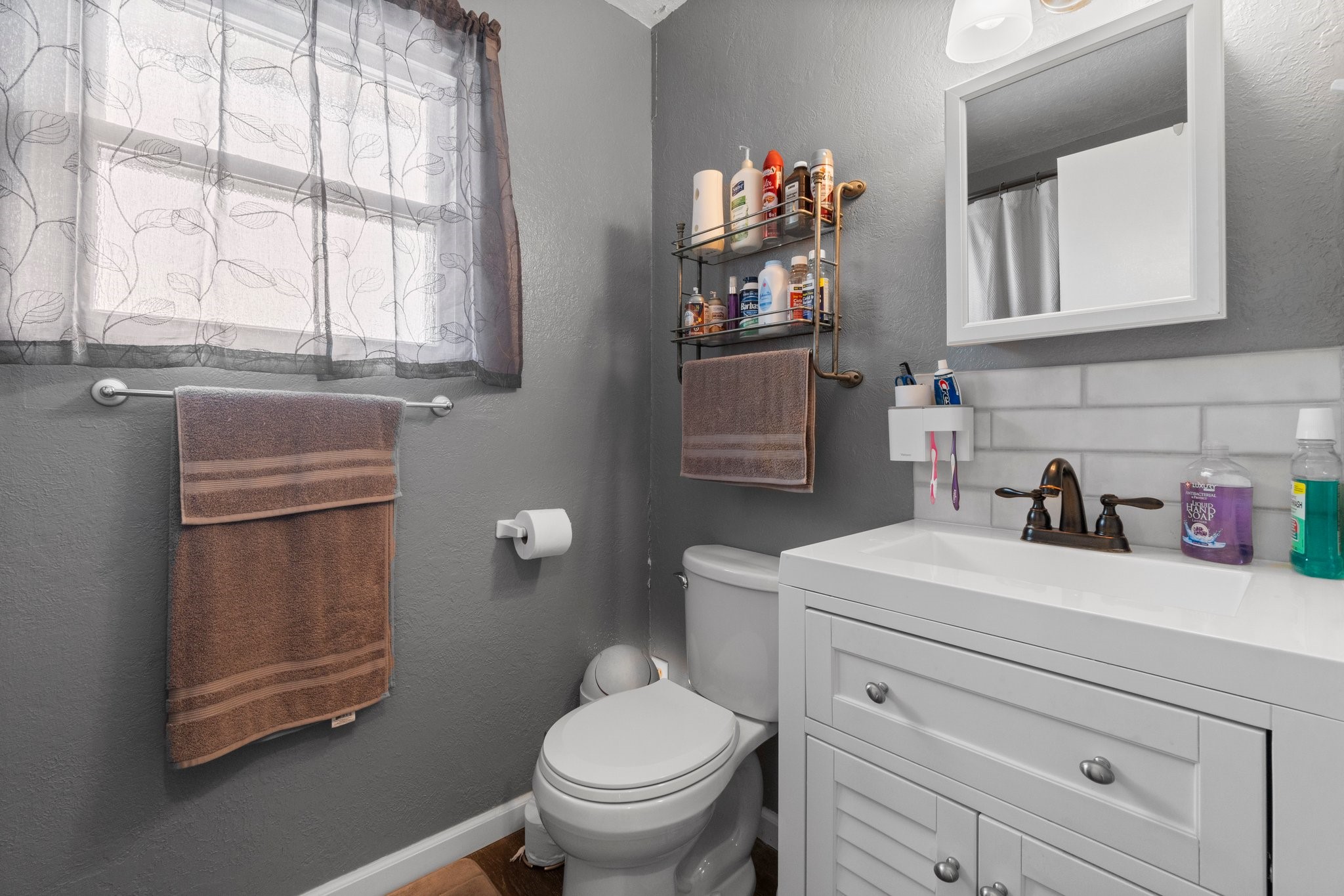 21 Clearview Point Blank, TX 77364 - Photo 21 of 43 a bathroom with a sink a toilet and a window