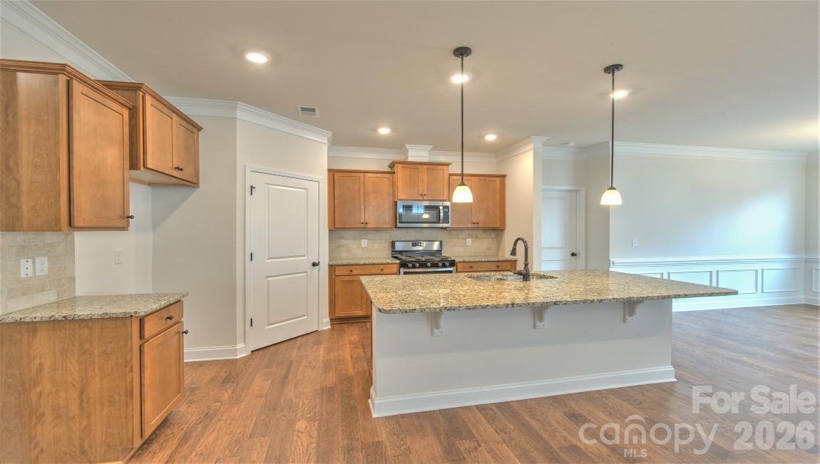 649 River Btm Road Fletcher, NC 28732 - Photo 11 of 40 a large kitchen with stainless steel appliances kitchen island a large counter top and a wooden floors