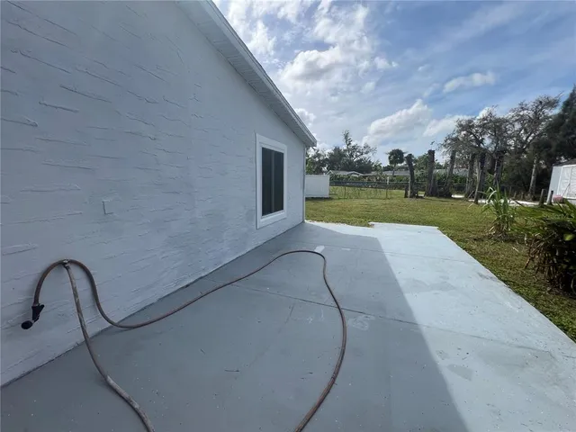 a view of a house with backyard and a tree