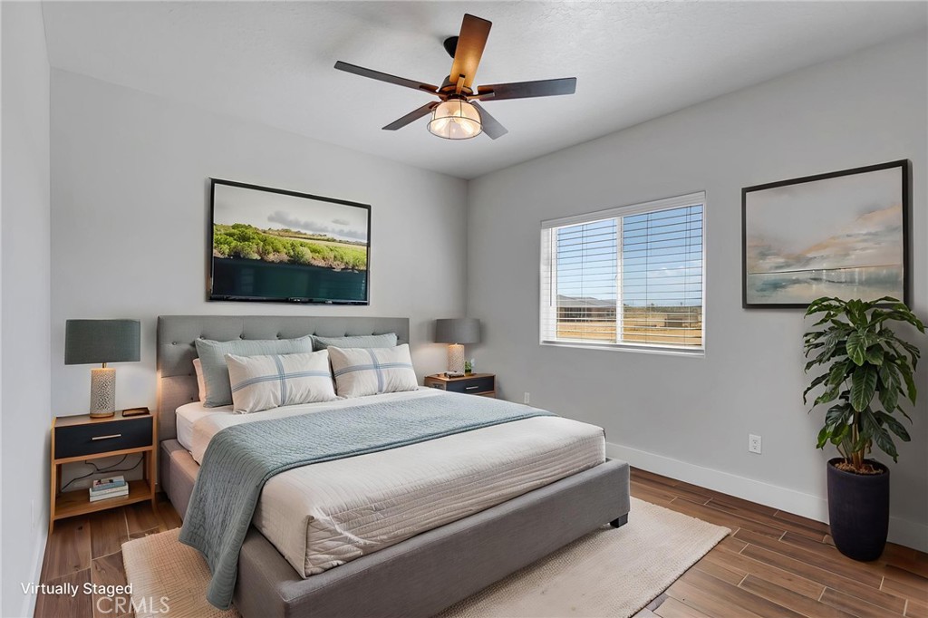 10055 Eaby Road Phelan, CA 92371 - Photo 17 of 19 a bedroom with a bed and a potted plant