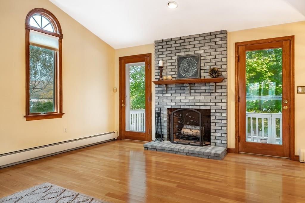 2 Alben Street Winchester, MA 01890 - Photo 15 of 33 a living room with a fireplace and a window