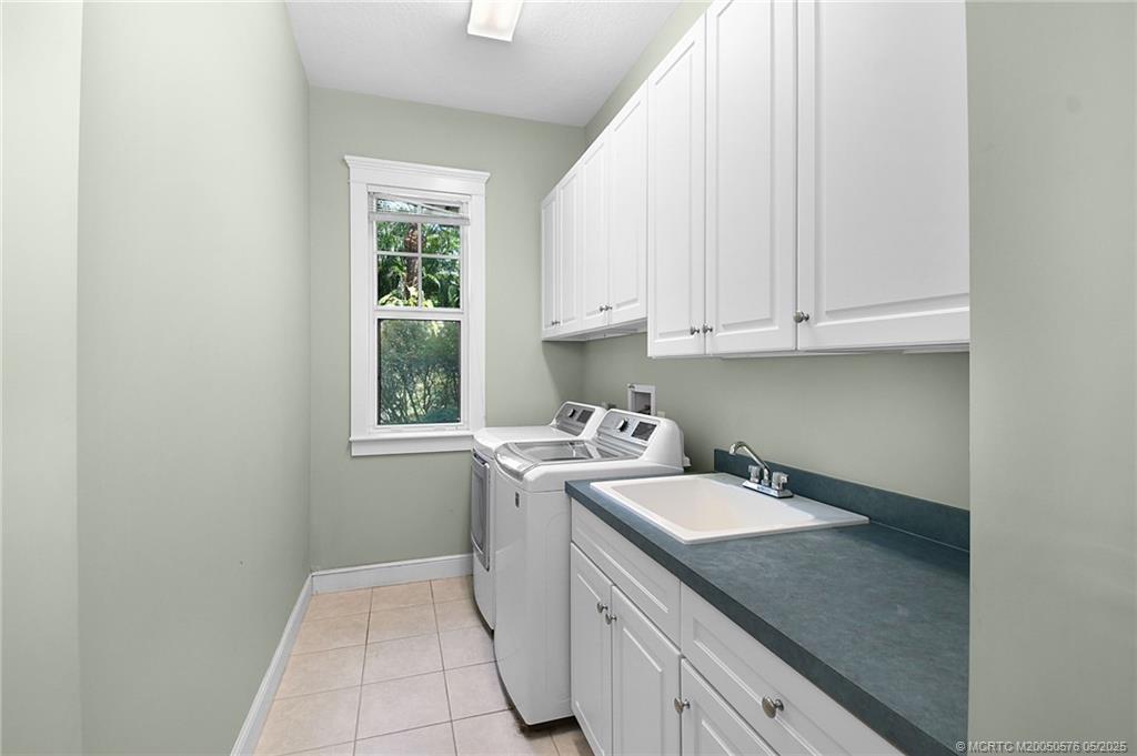 5327 Southeast Reef Way Stuart, FL 34997 - Photo 32 of 39 Laundry room with sink and additional storage.