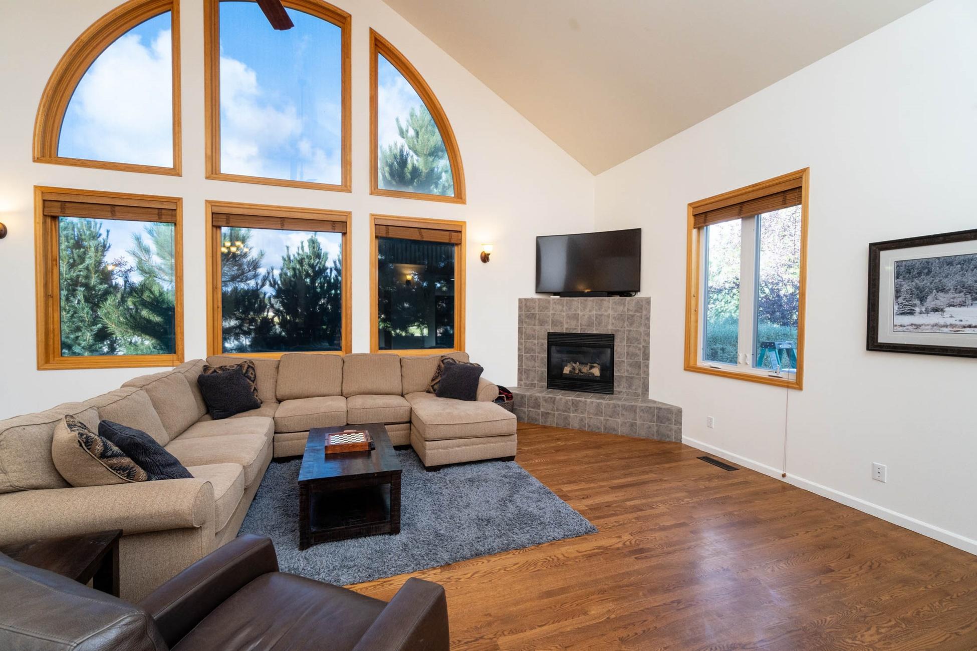 61899 Dobbin Court Bend, OR 97702 - Photo 6 of 26 a living room with furniture large window and a fireplace