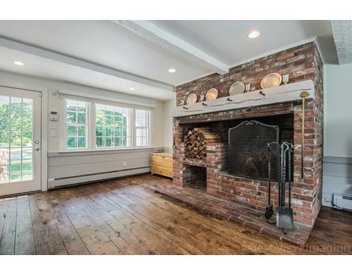 8 Jefferson Drive Acton, MA 01720 - Photo 5 of 38 a view of empty room with wooden floor and fireplace