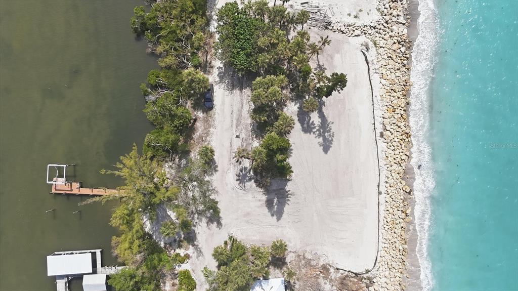 804 North Manasota Key Road Englewood, FL 34223 - Photo 22 of 23 an aerial view of a house with a yard and large trees
