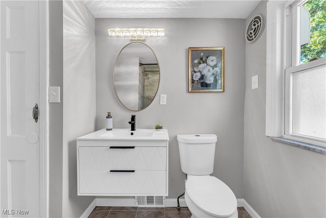 2425 Canterbury Road Cleveland Heights, OH 44118 - Photo 22 of 33 Bathroom featuring tile patterned flooring, vanity, toilet, and plenty of natural light