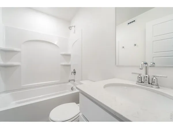 a bathroom with a sink a toilet and a bathtub