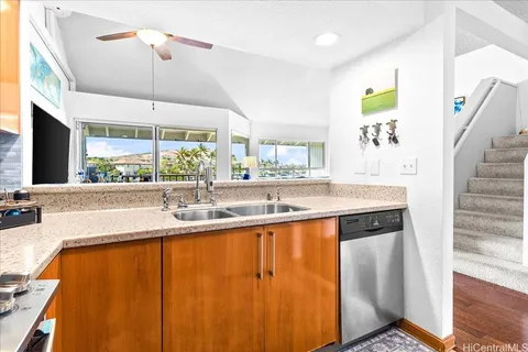 a large white kitchen with a large window