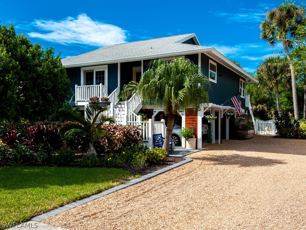 1434 Sand Castle Road Sanibel, FL 33957 - Photo 1 of 35 a front view of a house with garden