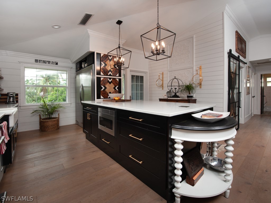 1434 Sand Castle Road Sanibel, FL 33957 - Photo 11 of 35 a kitchen with a wooden table and chairs